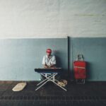 man in red jacket sitting on chair